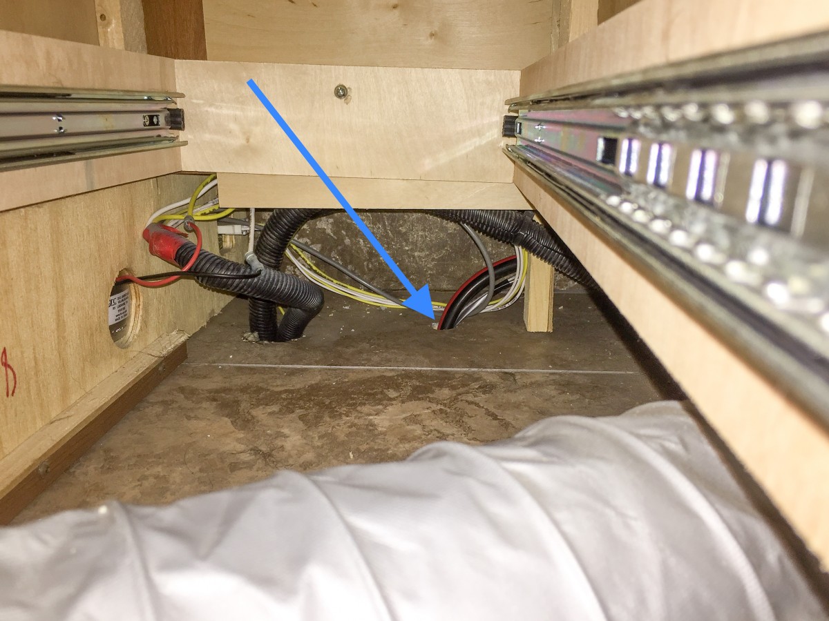 Routing the solar wires through a new hole into a storage compartment.